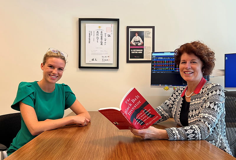 Mary and Meghan sitting at a desk.